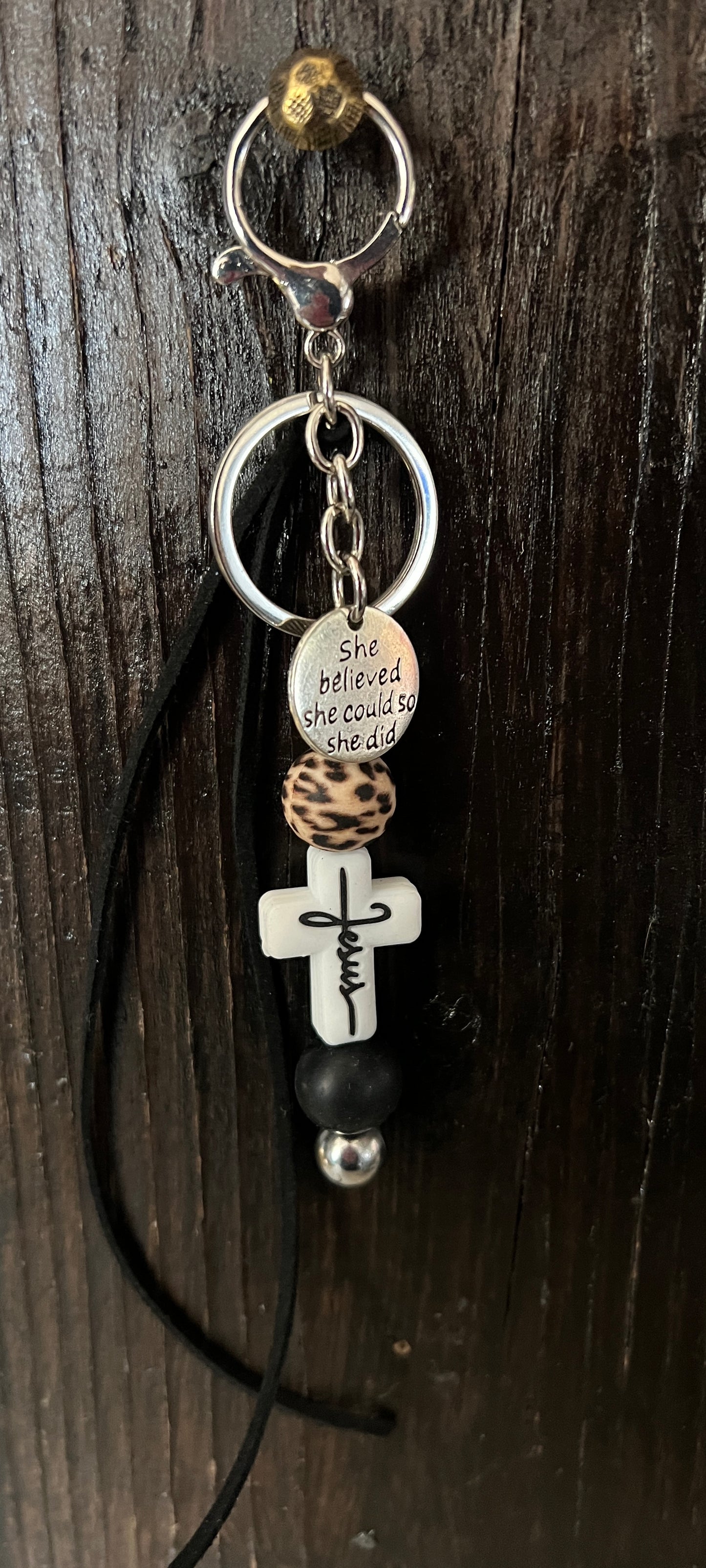 “Jesus” saddle charm (white cross, black and cheetah beads)